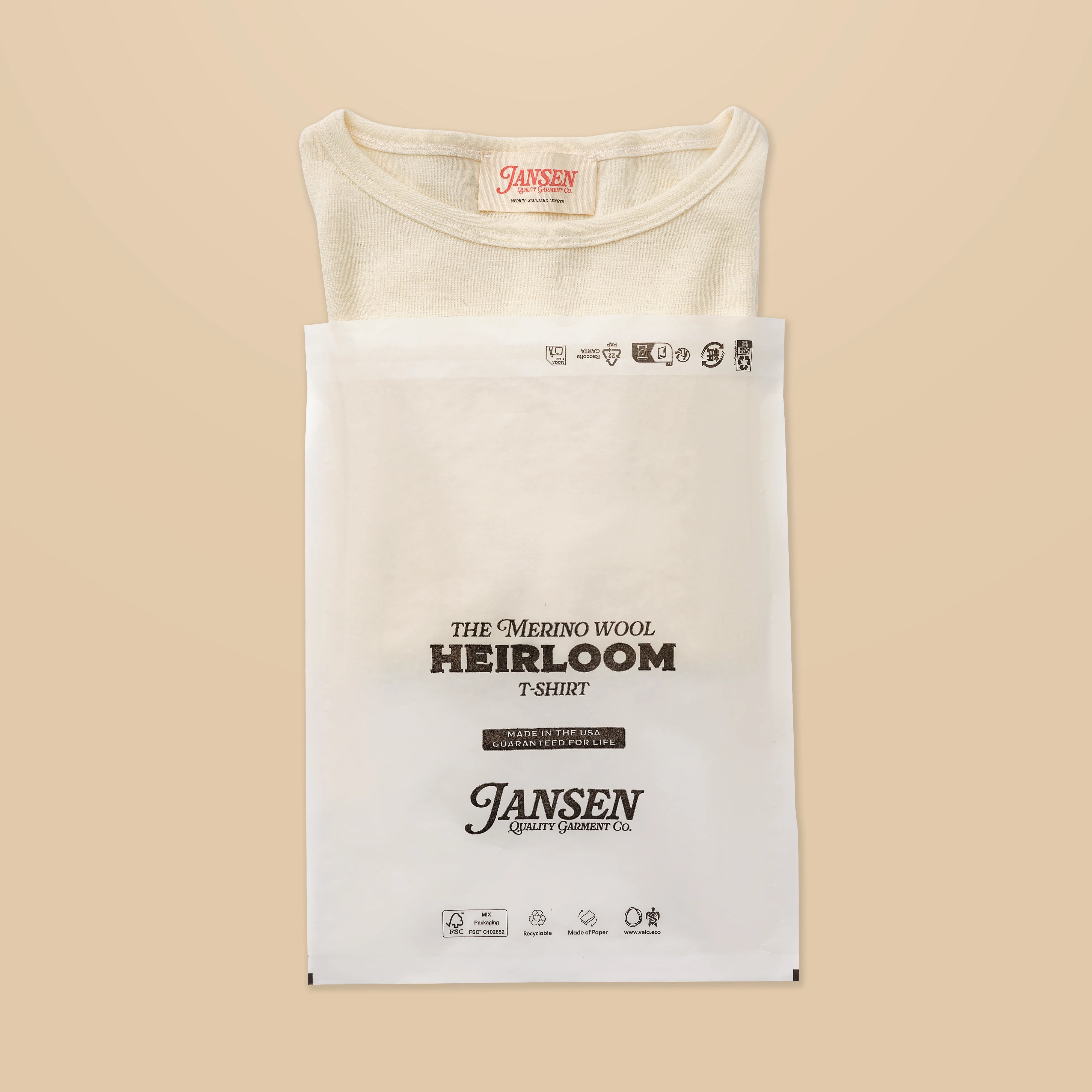 White/cream, packaged t-shirt with Jansen label on a beige background