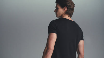 Video of male and female models moving slowly in black and white tees