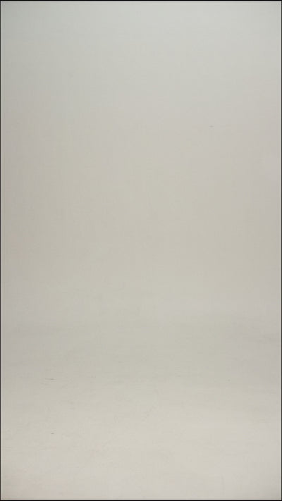 Video of a man wearing a black wool tee shirt and blue jeans walking into frame, turning to show the tee, then walking out of frame.